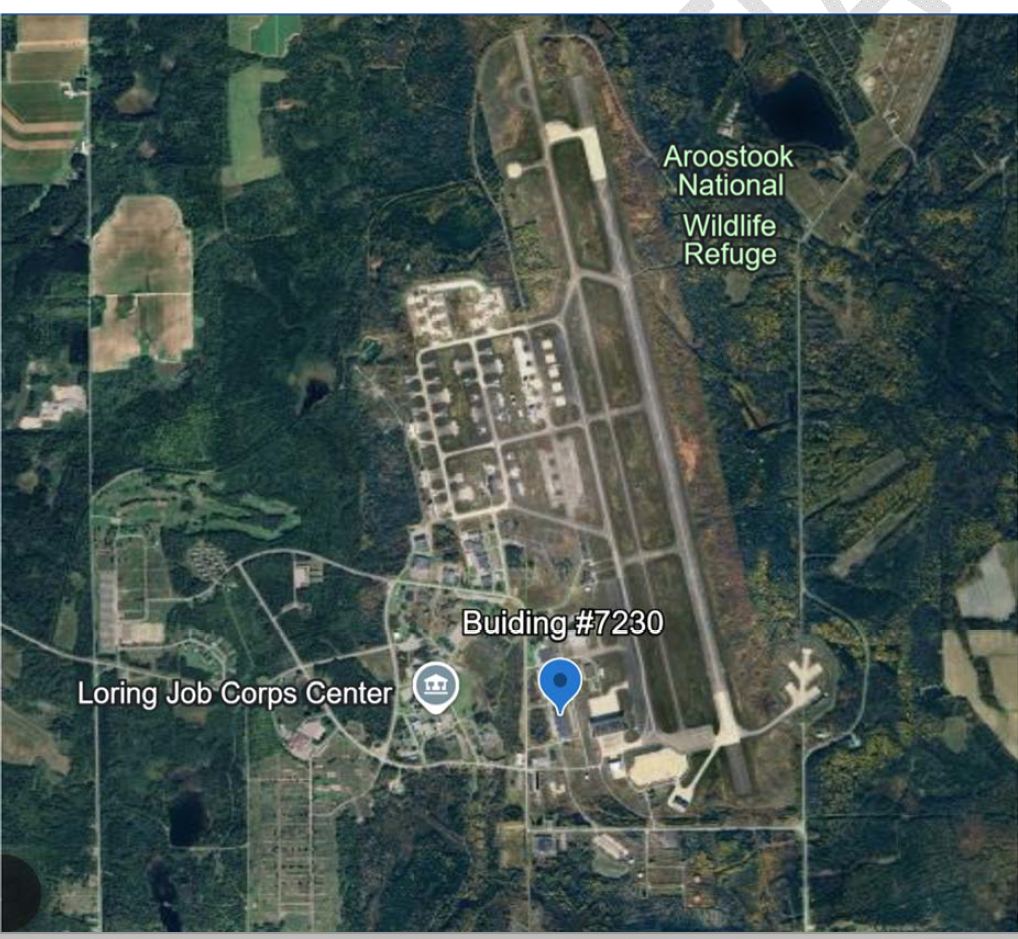 Aerial view of the former Loring Air Force Base showing the twin runways, the hangar line and Building 7230 pinned at the south end of the flight line, with the Aroostook National Wildlife Refuge to the northeast